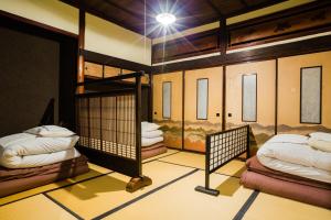 a room with two bunk beds in it at Guest House Kura in Suzaka