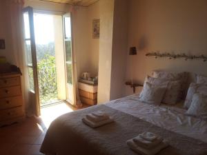 a bedroom with a bed with two towels on it at Le Petit Fabre in Montagnac