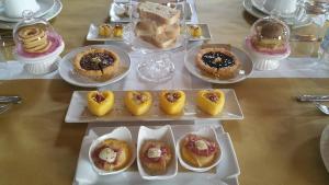 a table topped with different types of desserts on plates at Il Rifugio del Poeta in San Biagio di Callalta