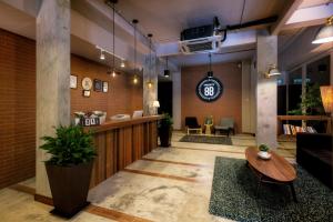 a lobby with a reception desk and a table at Hotel Twenty 8B in Kuala Lumpur