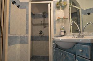 a bathroom with a sink and a shower at La Casarella Apartment Positano in Positano