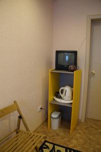 a tv sitting on a shelf in a room at Хостел Обской возле Толмачево in Ob
