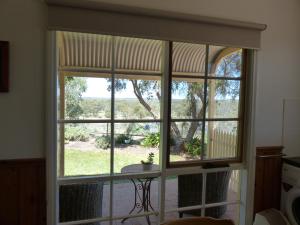 a window in a kitchen looking out at a yard at Glenbar cottage Yelta in Mildura