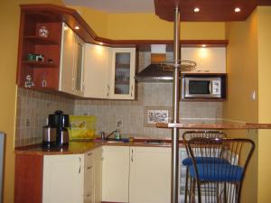 a kitchen with white cabinets and a counter top at Apartment Jola in Pobierowo