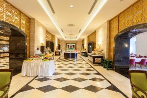a lobby of a hotel with tables and chairs at Melas Lara Hotel in Lara +152 photos