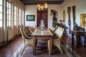 a dining room with a wooden table and chairs at El Asiento Del Azar in Banyeres del Penedes