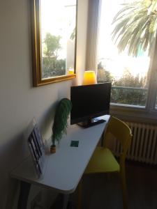 a desk with a computer on it in a room with a window at Hotel La Capannina in Genoa