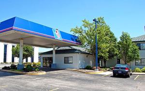 a gas station with a car parked in a parking lot at Motel 6-Kokomo, IN in Kokomo