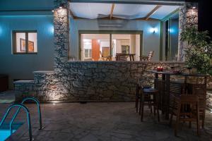 a bar with chairs and a stone wall at Panorama Villa Private Pool, BBQ, Parking in Sitia