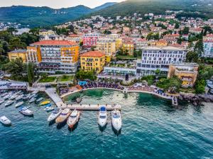 a group of boats in the water in a city at Amadria Park Grand Hotel 4 Opatijska Cvijeta in Opatija