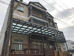 a building with awning on the front of it at Home Coming in Xiaoliuqiu