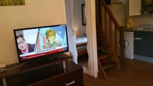 a flat screen tv sitting on top of a dresser at Résidence Cap Azur Maison N° 56 in Villeneuve-Loubet