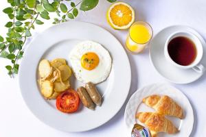 una mesa con dos platos de desayuno y una taza de café en Ashling Villa, en Amed