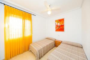 a bedroom with two beds and a window at ALEGRIA ID51 in Orihuela Costa