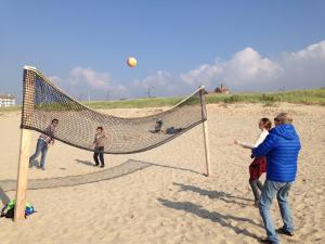 a group of people playing volleyball on the beach at Chalet Parfait in Bergen +5 photos