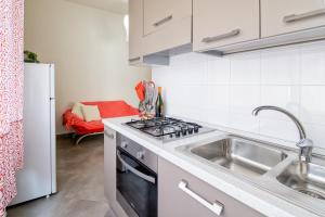 a kitchen with a sink and a stove top oven at La Tortuga in Agropoli