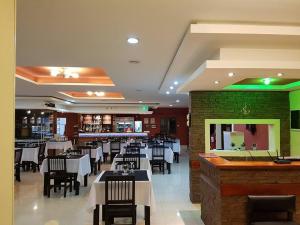 a restaurant with tables and chairs and a bar at Che Cauquen in Puerto Santa Cruz