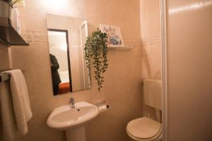 a bathroom with a sink and a toilet and a mirror at Sagres 30 Seconds to Bars in Sagres