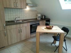 a kitchen with a table with a bowl of fruit on it at Haus Schönblick in Bad Bertrich