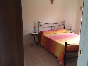 a bedroom with two beds and two tables at Gugliormella in Sirolo +12 photos