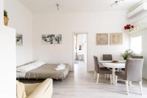 un soggiorno bianco con letto e tavolo di White terrace apartment navona a Roma