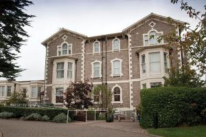 a large brick building with white windows on a street at Lauriston Hotel in Weston-super-Mare