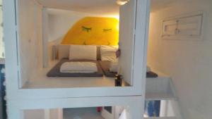 a small room with a bed in a small room at Appartamento Ellen in Nago-Torbole +7 photos
