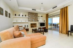 a living room with a couch and a fireplace at Aroma Villas in Hersonissos