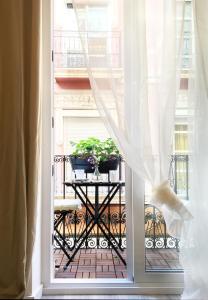 an open window with a table with plants on a balcony at Apartment Muñoz 2 in Alicante