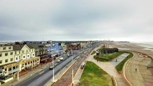 a view of a city with a street and the ocean at Craig-y-Don in Blackpool