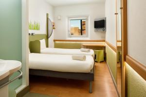 a hospital room with two beds and a sink at ibis budget London Hounslow in Hounslow