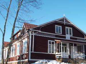 a large black house with white trim at Porvoo Hostel in Porvoo