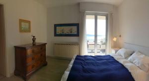 a bedroom with a bed and a dresser and a window at Selva 1 in Ghiffa