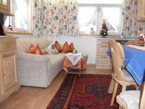a living room with a couch and a table at Ferienalm in Ruhpolding