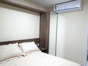 a bedroom with a white bed and a air conditioner at VG Sun Cumbuco in Cumbuco +16 photos