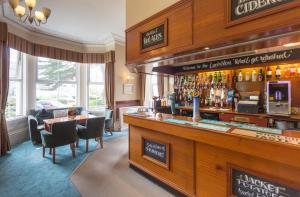 a bar in a hotel with a table and chairs at Lauriston Hotel in Weston-super-Mare