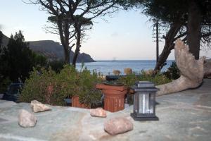 a view of the ocean from a patio with rocks at Lampi's House in Patmos