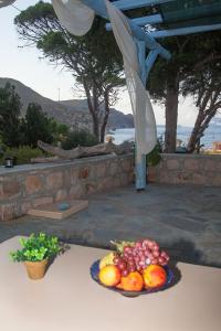 a plate of fruit sitting on a table at Lampi's House in Patmos