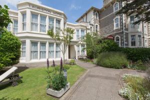 a building with a garden in front of it at Lauriston Hotel in Weston-super-Mare