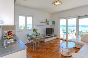 a kitchen and living room with a table and a couch at Villa Luciana in Trogir