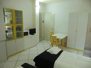 a bedroom with a bed and a desk and a table at Villa Alma in Bologna