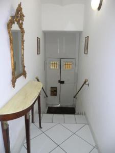 a room with a hallway with a mirror and a door at Villa Alma in Bologna