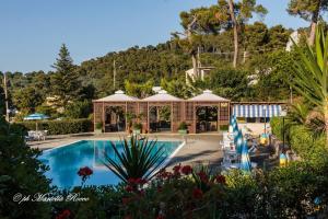 a resort with a swimming pool and a building at Camping Villaggio Internazionale in San Menaio