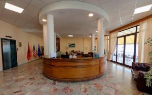 a law office with a wooden reception desk at Hotel New York in Vlorë