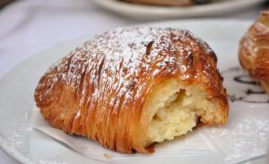 a pastry on a plate with powdered sugar on it at Villa Azzurra in Conca dei Marini +31 photos