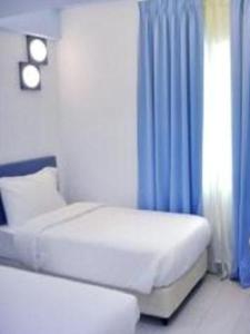 Postel nebo postele na pokoji v ubytování YY318 Hotel Bukit Bintang