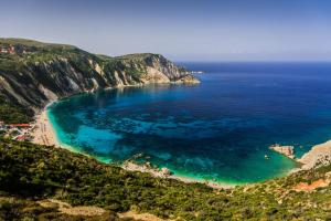 una vista aerea di una spiaggia con acqua blu di Residence Poseidon a Spartià