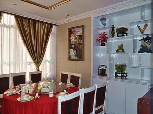 a dining room with a red table and chairs at Greentree Inn Shanghai Chongming Bao Town Express Hotel in Chongming