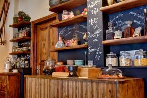 a kitchen with a counter with a chalkboard on the wall at Gastronomy Hotel Kritsa in Portaria