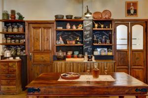 a kitchen with wooden cabinets and a wooden table at Gastronomy Hotel Kritsa in Portaria